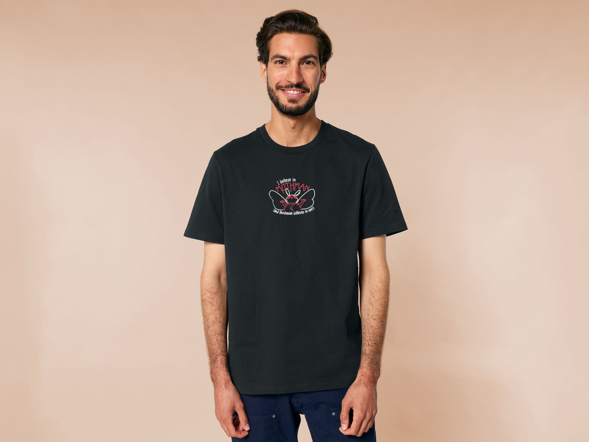 Embroidered black t-shirt with a cute chibi cryptid design of Mothman with the text I believe in Mothman (and Mothman believes in me!)