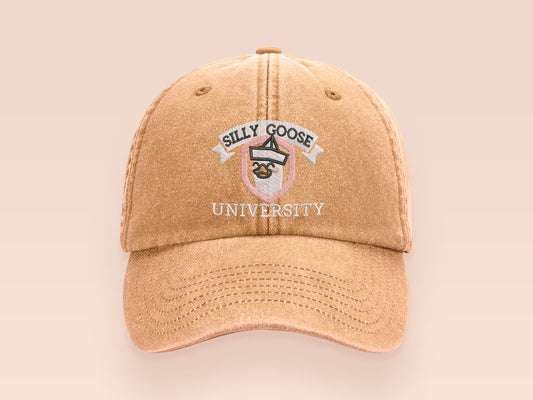 A vintage yellow baseball cap hat with an embroidered cute goose wearing a paper hat with the quote Silly Goose University
