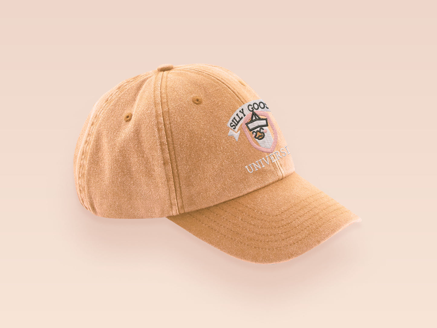 A vintage yellow baseball cap hat with an embroidered cute goose wearing a paper hat with the quote Silly Goose University